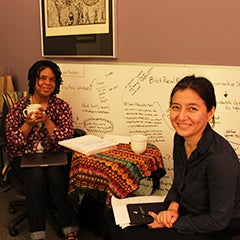 A faculty member and writing coach talking one on one in an office