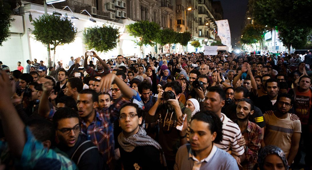 crowd of protesters in a street in Egypt