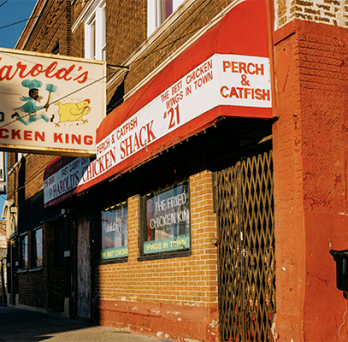 Harold's chicken shop with bright red awning and red brick 
